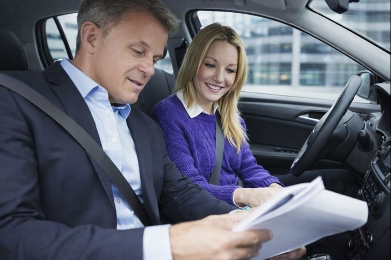 Students learning driving theory in bright classroom